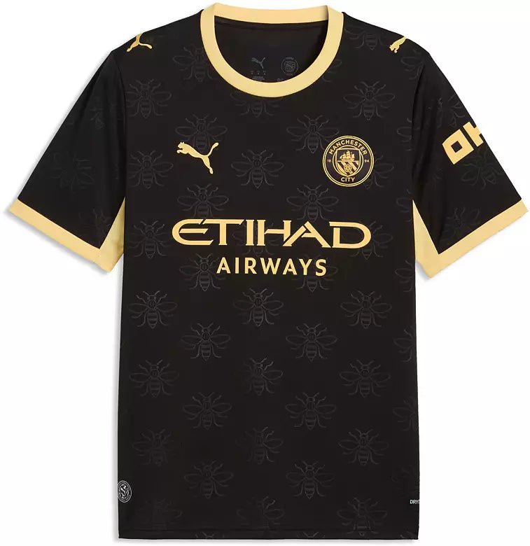 A black Puma Manchester City football jersey with gold trim, featuring the gold Puma logo, Manchester City crest, and Etihad Airways sponsor text on the front.