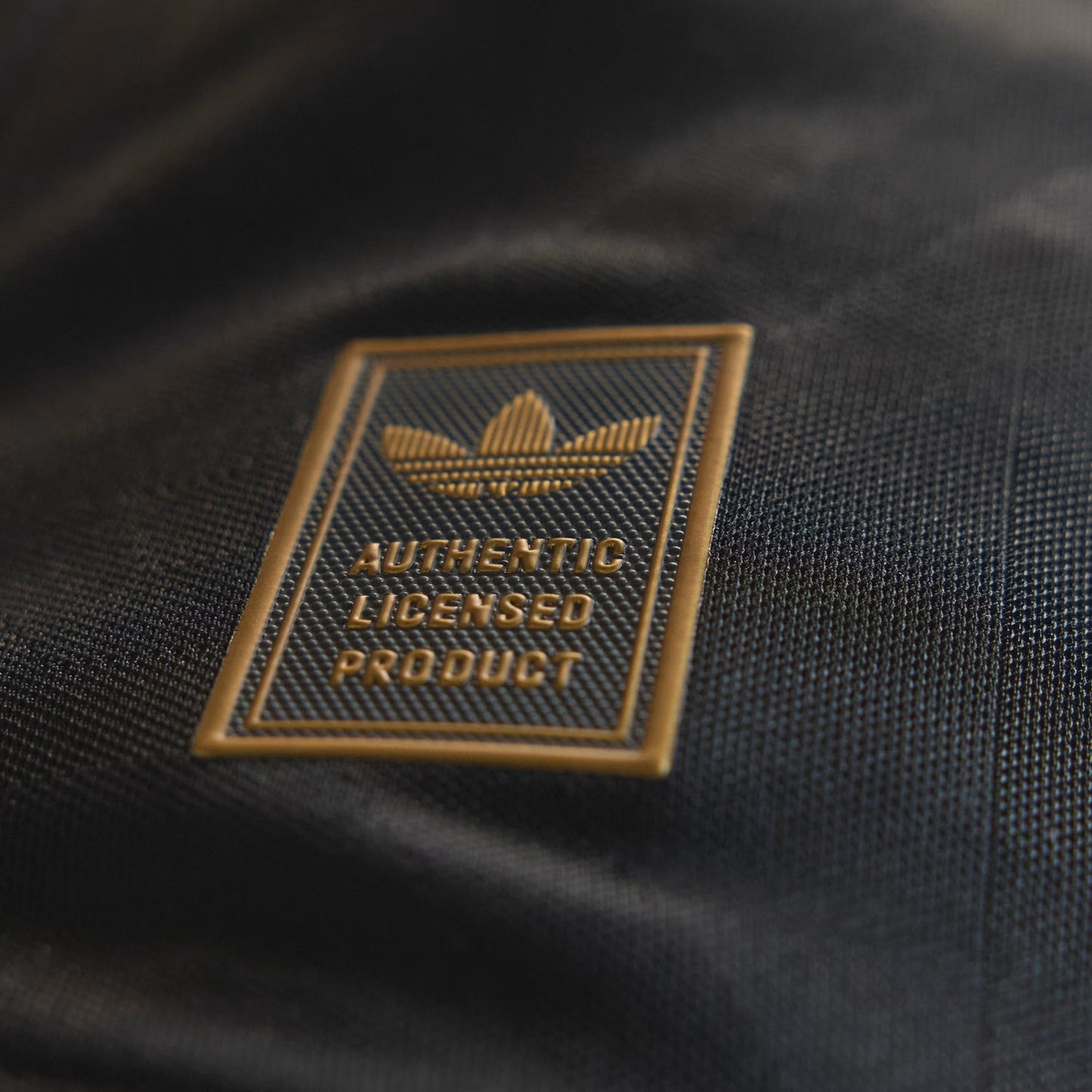 Close-up of an Adidas logo on a black product