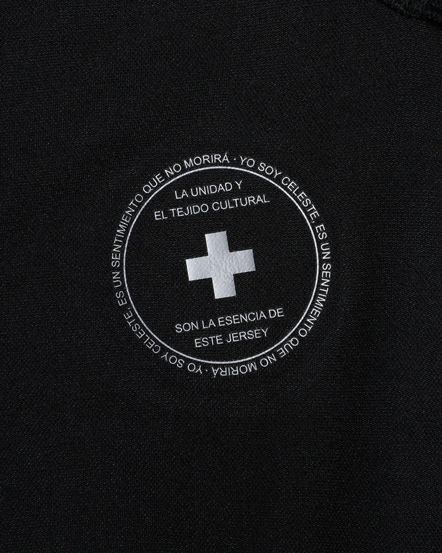 Black jersey with white text and cross emblem on a black background
