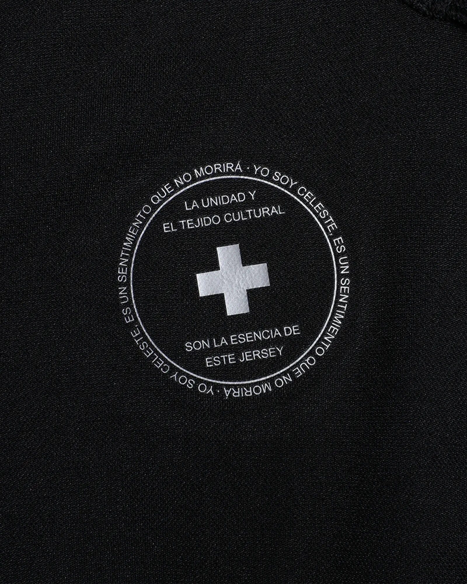 Black jersey with white text and cross emblem on a black background