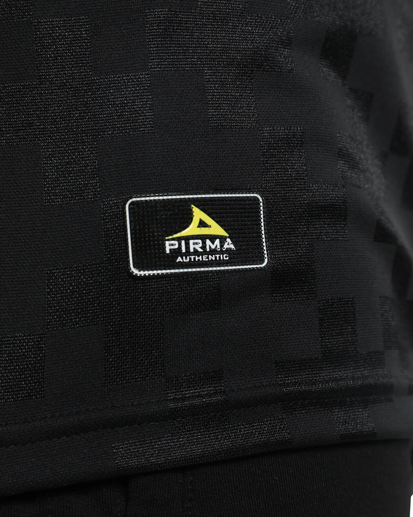 Black fabric with a Pirma logo patch on a dark background