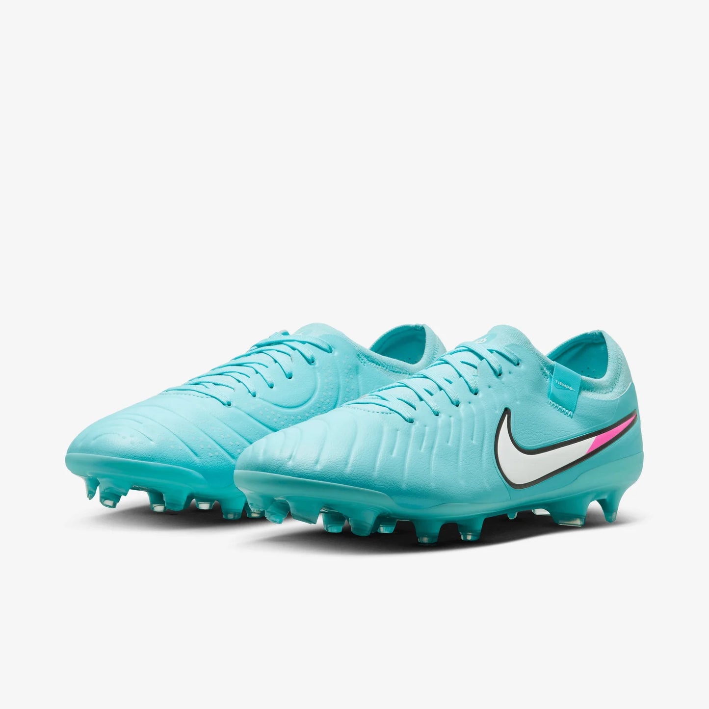 Turquoise soccer cleats with Nike logo on a white background