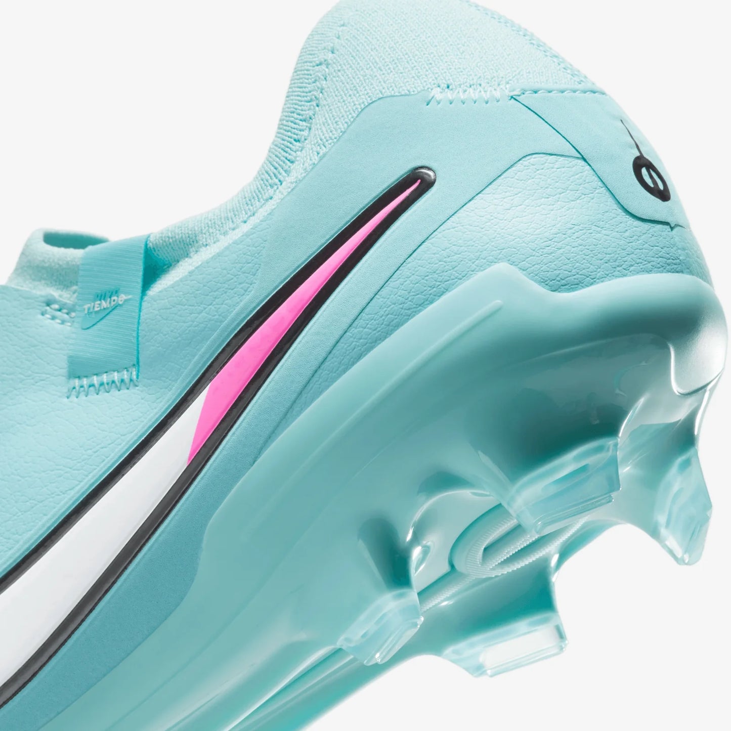 Close-up of a light blue athletic shoe with pink accents on a white background