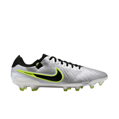 Silver soccer cleat with black and green accents on a white background
