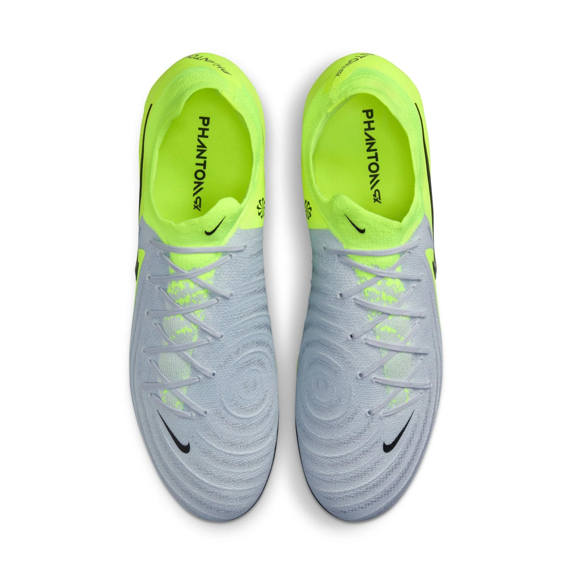 Pair of gray and neon green soccer cleats on a white background
