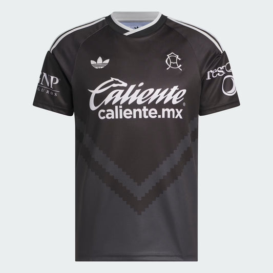 A black Adidas Caliente soccer jersey with white sponsor logos and shoulder stripes, shown against a light gray background.