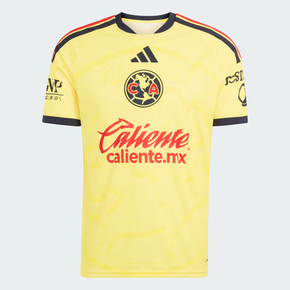 A yellow Club América soccer jersey by Adidas, featuring the club crest, red 'Caliente' sponsor logo, and black and red shoulder stripes, shown on a light gray background.