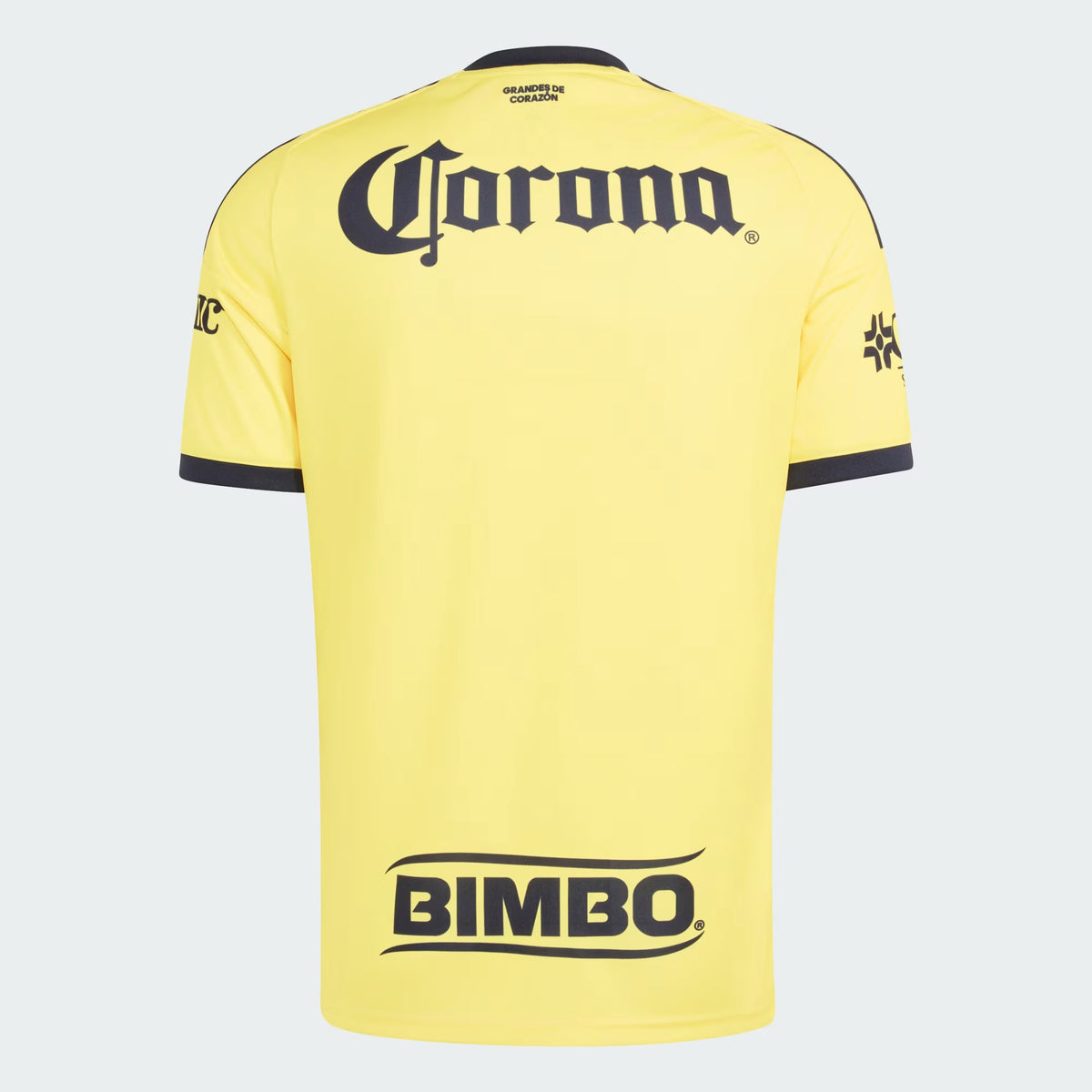 Yellow short-sleeve soccer jersey shown from the back, featuring a large black Corona logo across the upper back, a smaller Bimbo logo near the lower back, and black trim on the collar and sleeve cuffs.