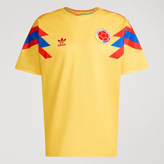Yellow sports jersey with Adidas logo and Colombian flag design on a gray background