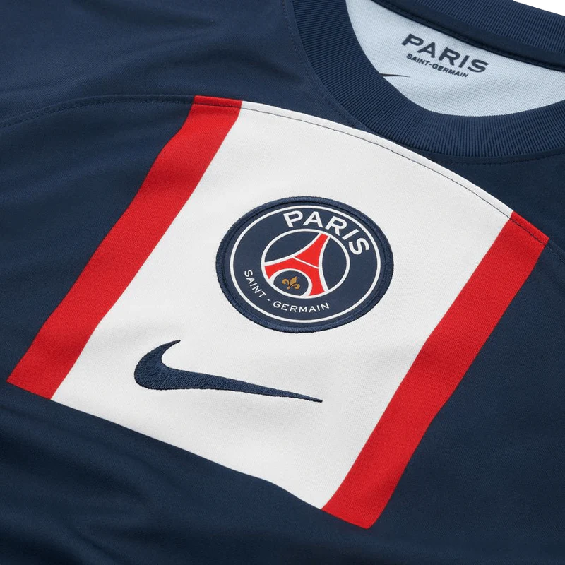 Close-up of a Paris Saint-Germain sports jersey with logo and Nike swoosh.