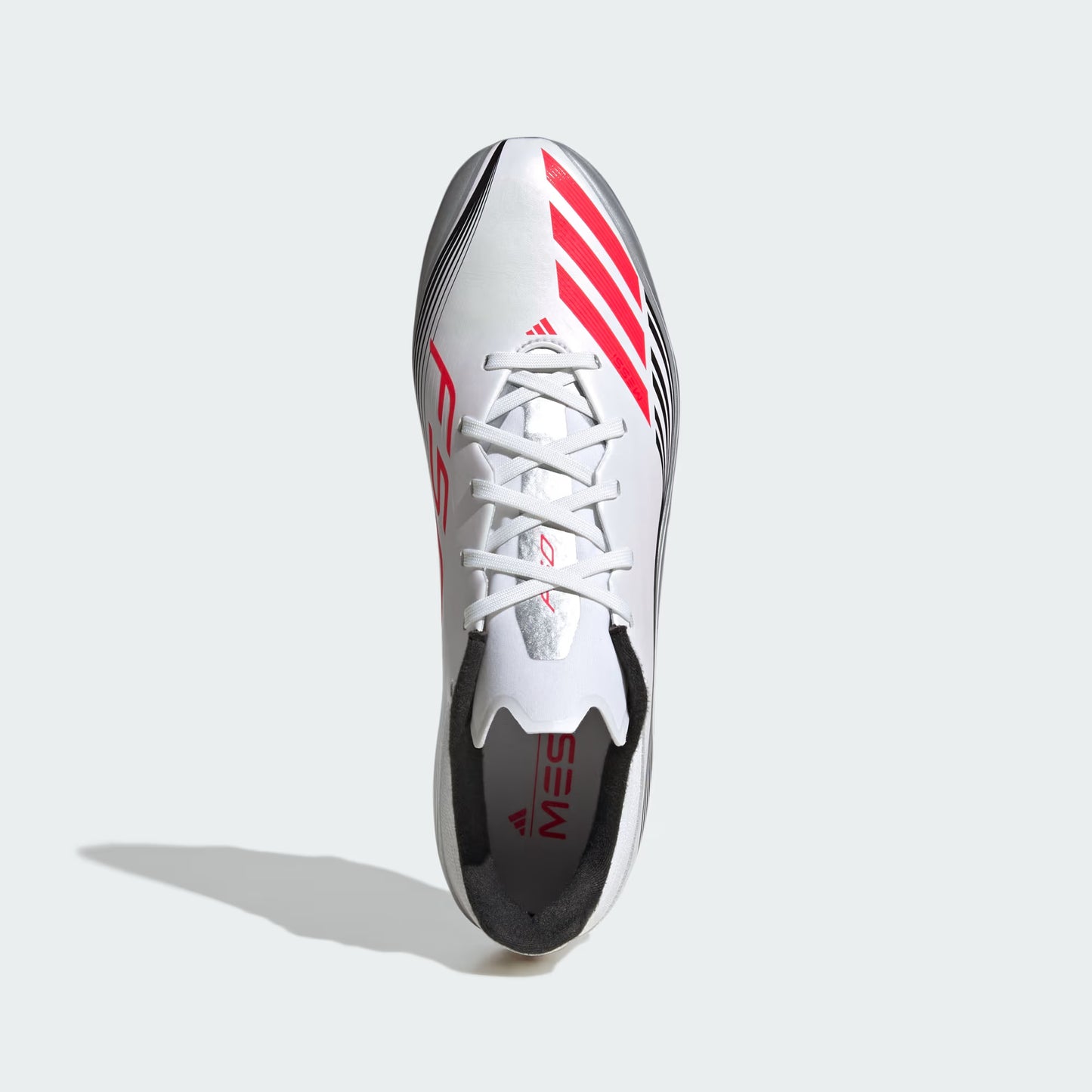 Silver sports shoe with red accents on a light gray background