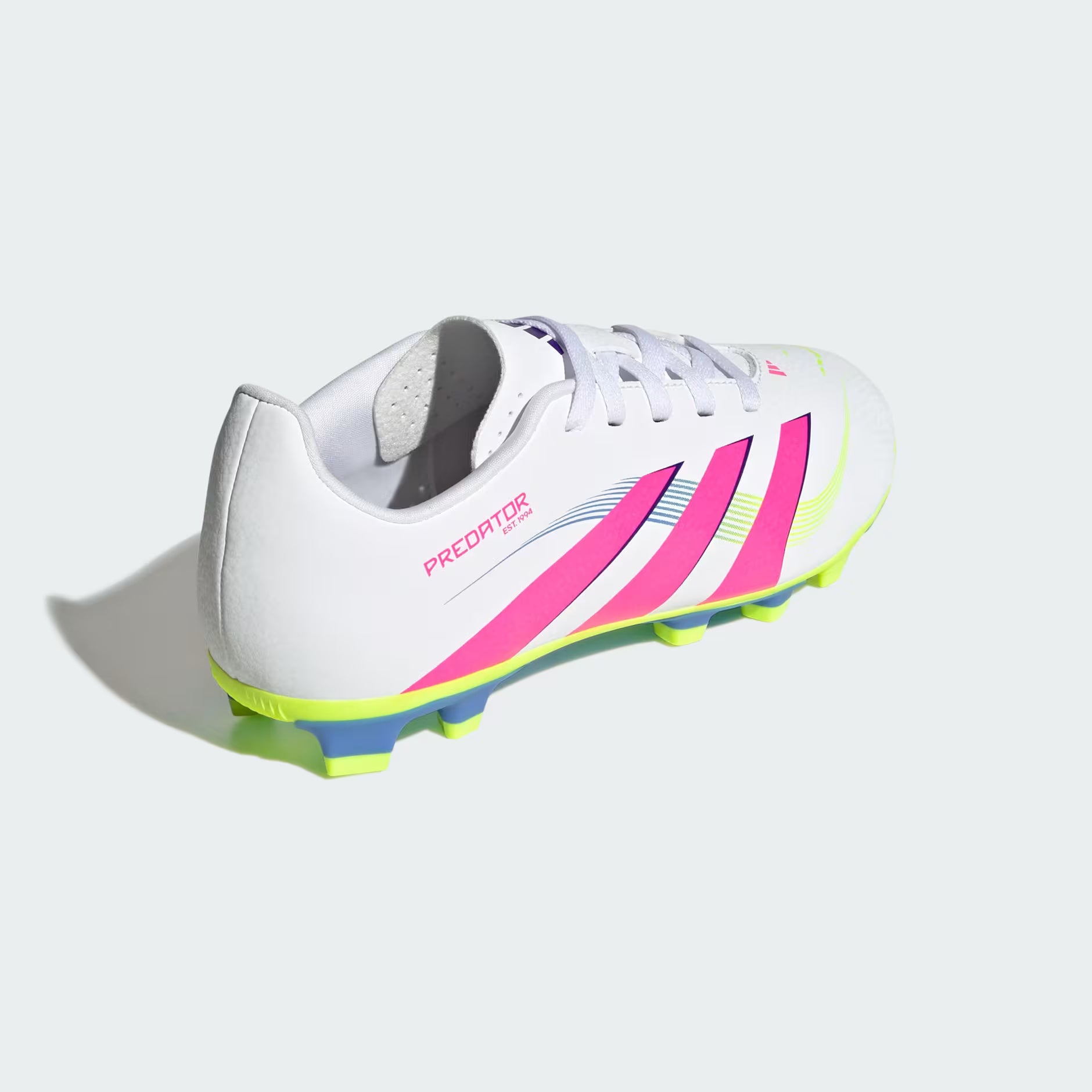White soccer cleat with pink and blue accents on a light gray background