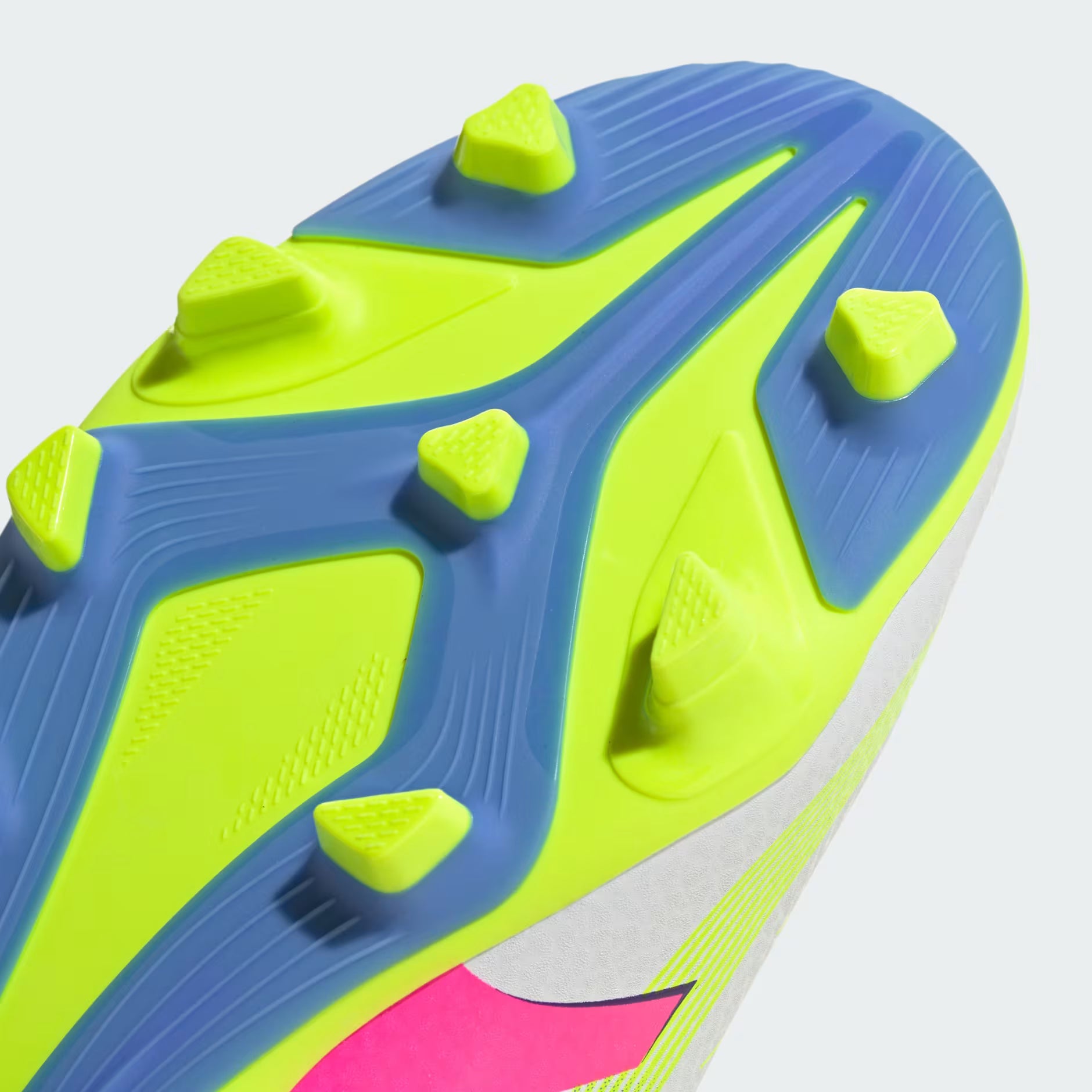 Close-up of a sports shoe sole with blue and green patterns on a white background