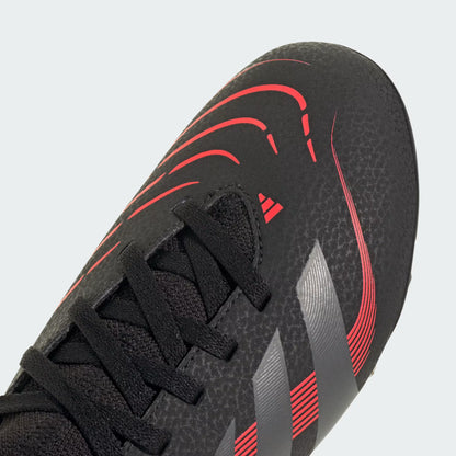 Black and red soccer shoe with a textured sole on a light gray background
