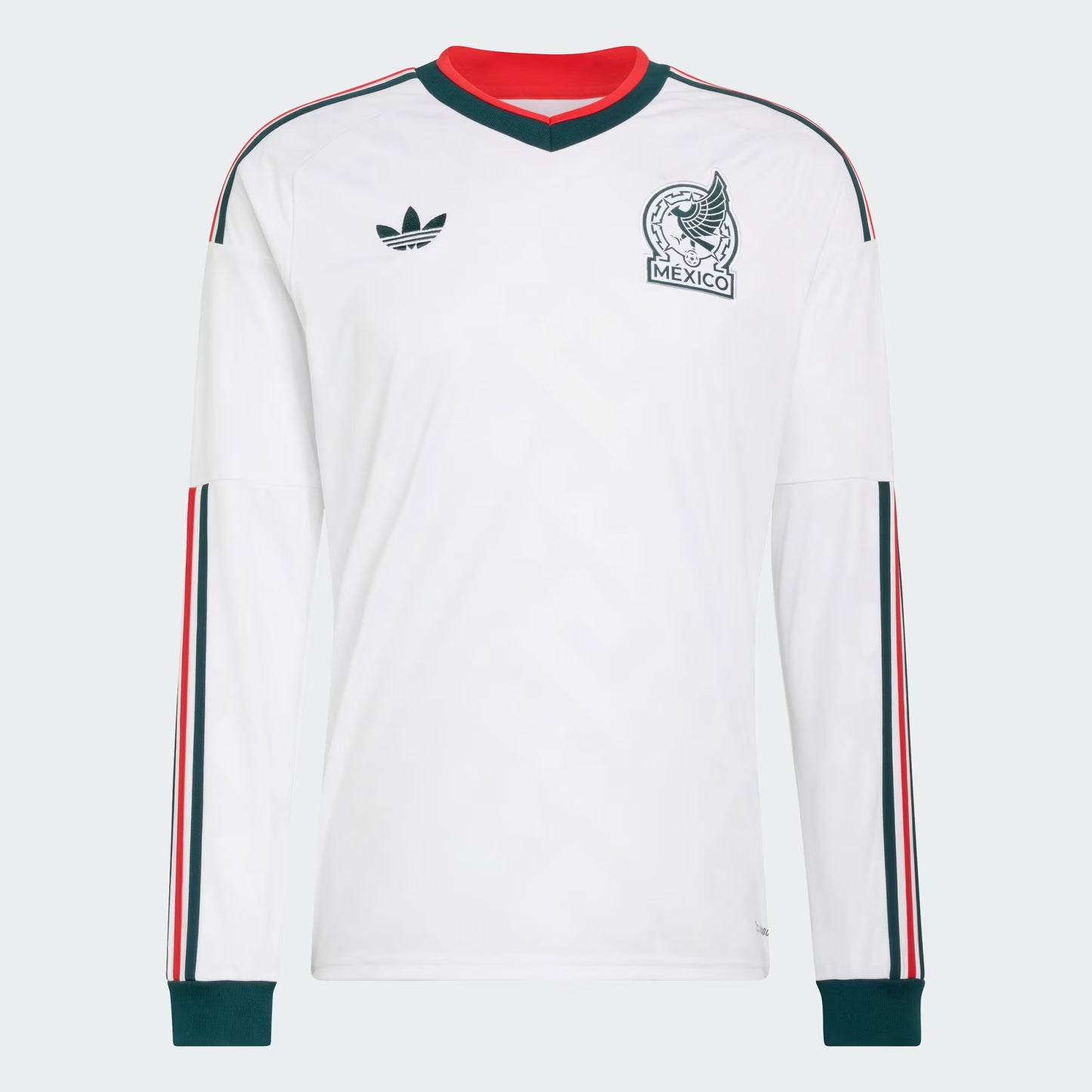 White long-sleeve shirt with red and green accents, featuring Adidas logo and Mexico emblem on a light gray background.