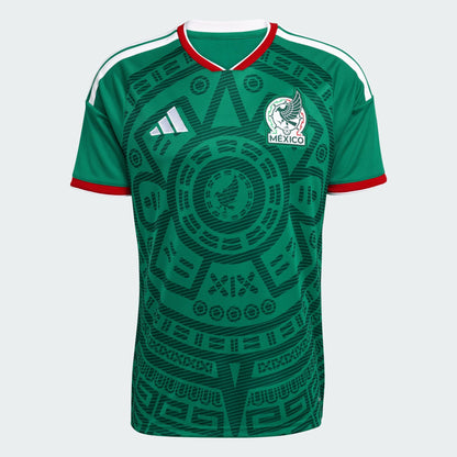 Green soccer jersey with Adidas logo and Mexico emblem on a light gray background