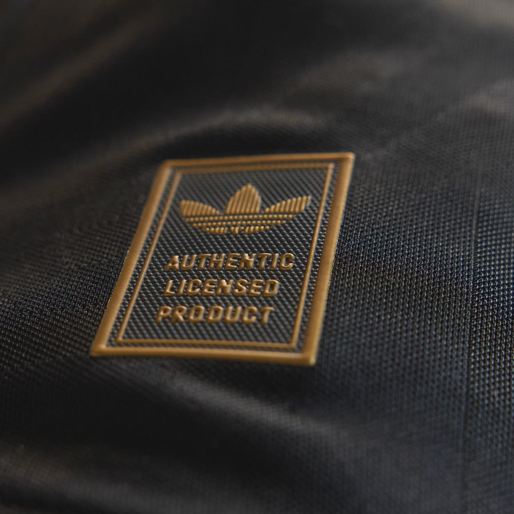 Close-up of an Adidas logo on a black product