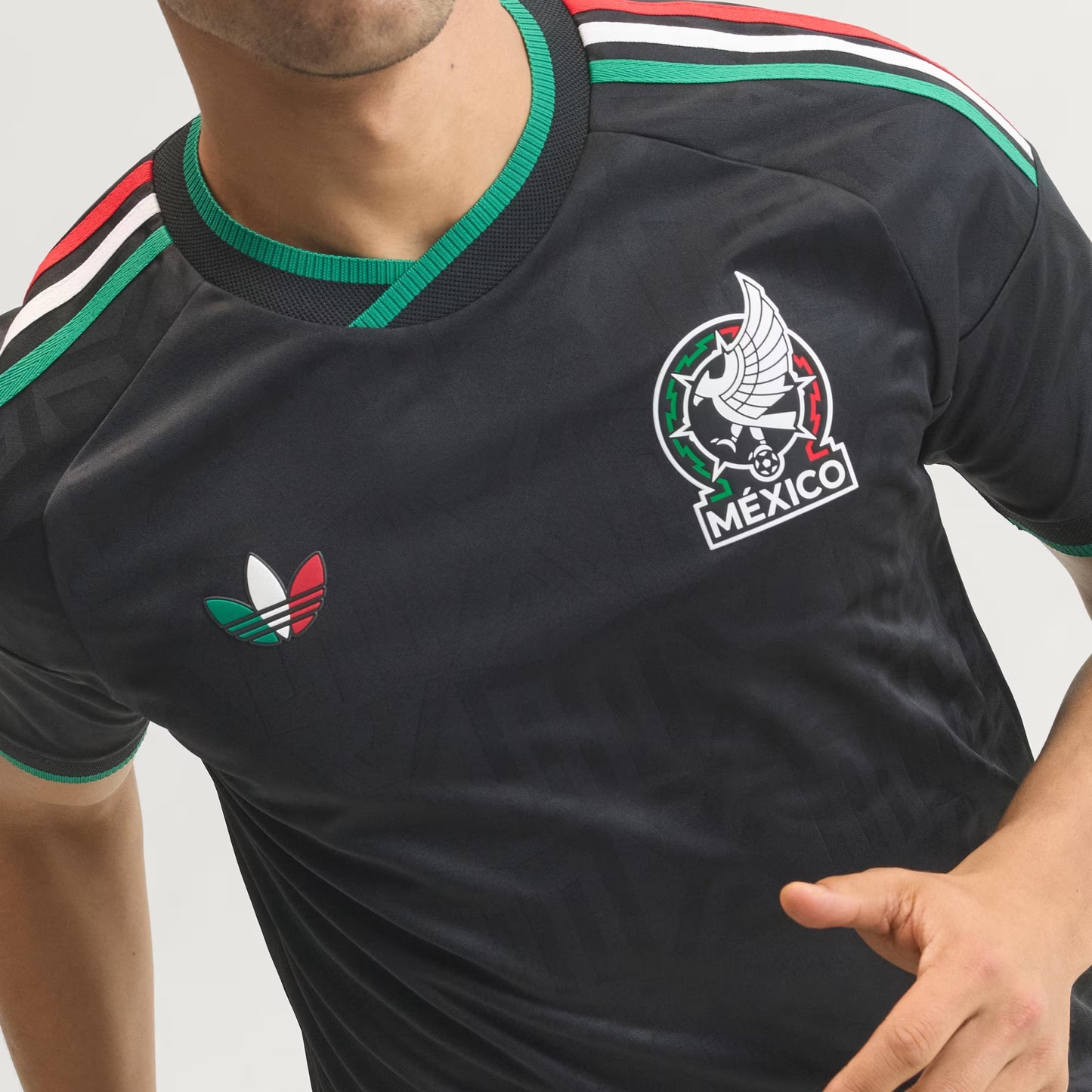 Black sports jersey with Adidas logo and 'Mexico' emblem on a gray background