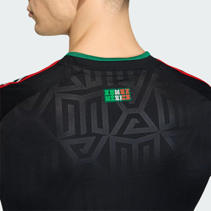 Black sports jersey with geometric patterns and a logo on the back, worn by a person.