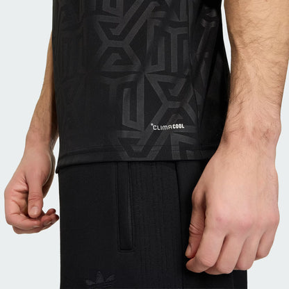 Person wearing a black sleeveless shirt with geometric pattern and 'ClimaCool' text, standing against a white background.