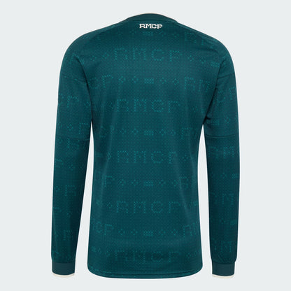 A dark teal long-sleeve athletic shirt with an all-over tonal RMCF logo pattern, shown from the back on a white background.