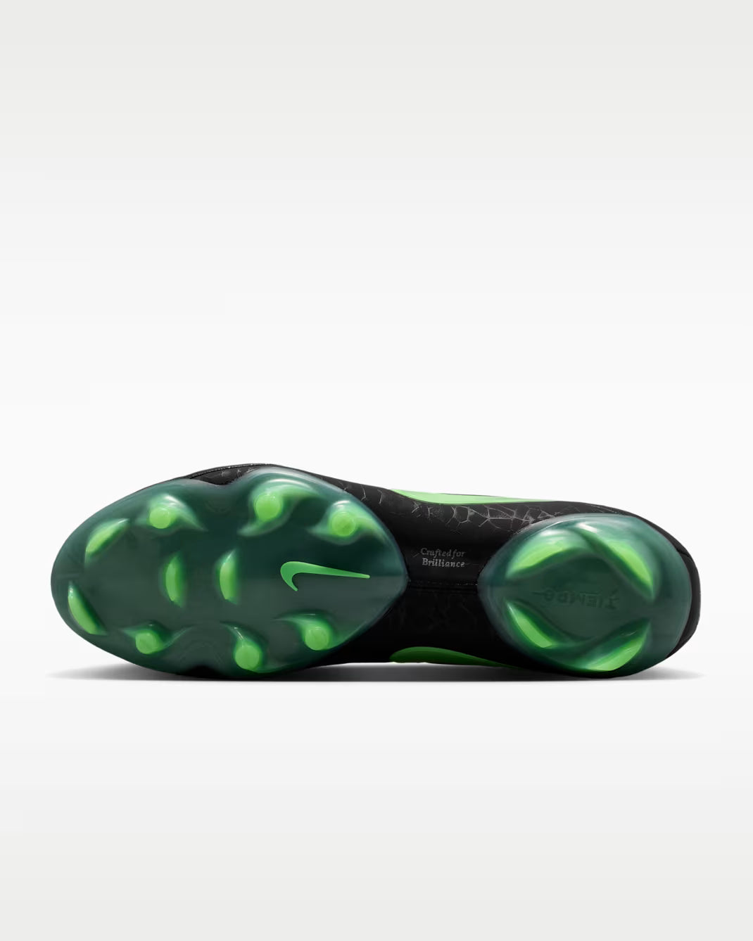 Close-up of a green and black Nike shoe sole on a white background