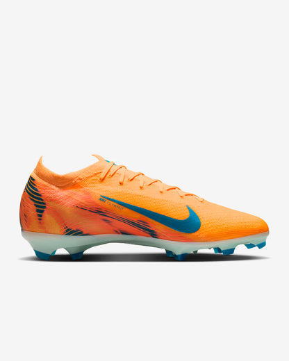 Orange soccer cleat with blue accents on a white background