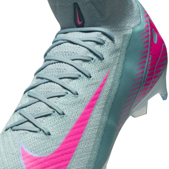 Gray and pink athletic shoe with Nike logo on a white background