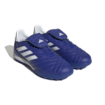 Blue soccer cleats with white stripes on a white background